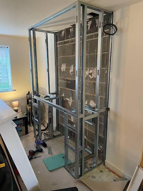 A Walk in the Park, The steel frame for the fireplace wall going up against the chimney breast, before any boarding